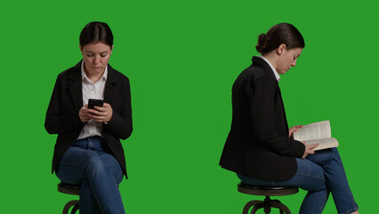 Close up of manager reading book and texting messages on camera, sitting on chair. Employee focusing on novel chapter to read tale, enjoying story and wearing suit over greenscreen backdrop.