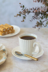 Coffee and dessert from waffle rolls with cream.