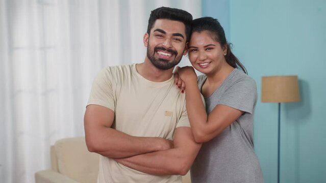 Happy smiling Indian couples confidently standing by looking camera at new home - concept of weekend relaxation, New Beginnings and Relationship Goals.