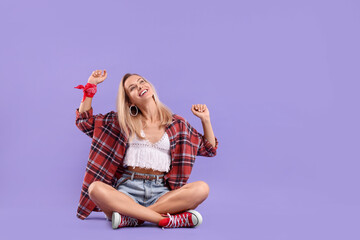 Happy hippie woman on purple background. Space for text