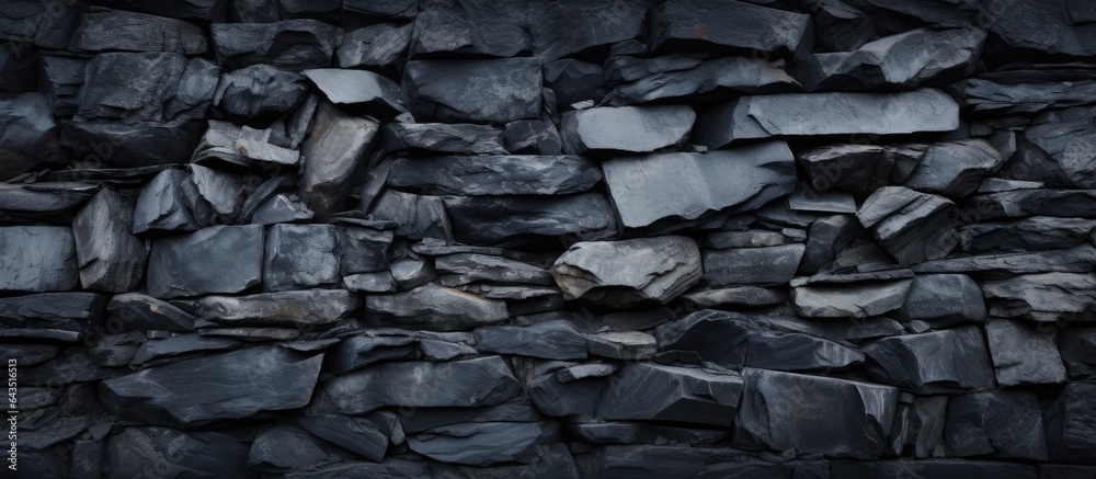 Poster texture and pile of rocks in a black stone background on a wall surface