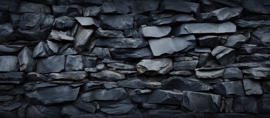 Texture and pile of rocks in a black stone background on a wall surface