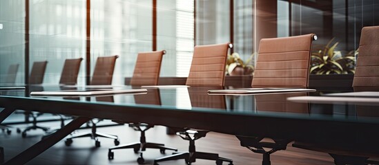 Close up of an empty conference room with a brown table black office armchairs a white meeting board and a clear glass wall with reflections