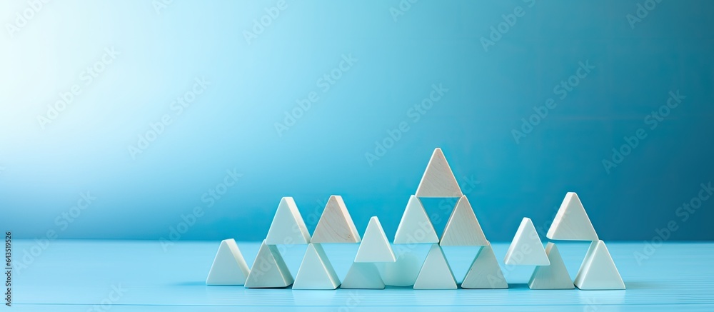 Aufkleber text space available on light blue background with a pyramid of wooden cubes