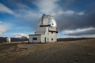 Indian Astronomical Centre in Hanle stands tall against a backdrop of a vivid blue sky adorned with...