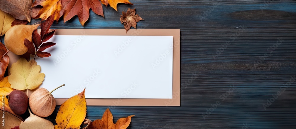 Aufkleber top view of table with blank paper and dried leaves perfect for an autumn composition