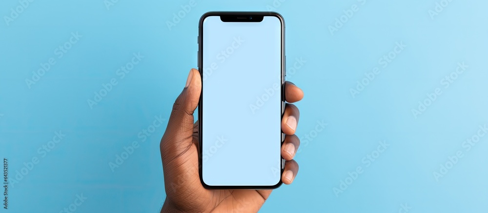 Aufkleber an african american man s hand displaying an empty smartphone screen against a blue background indic