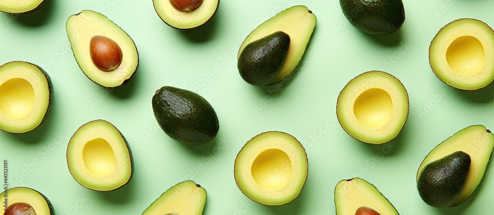 Aufkleber avocado halves arranged in a pattern on a vibrant mint green background
