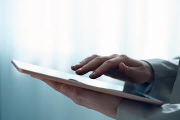 Closeup view of woman using modern tablet on blurred background