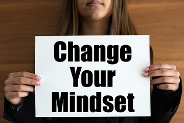 Change your mindset. Woman with white page,  black letters and the text, change your mindset.