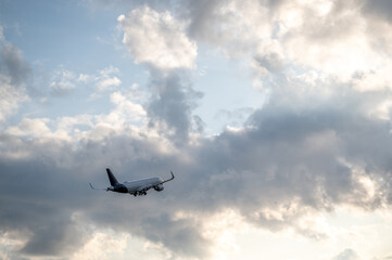 Passenger plane in sky with clouds taking off
