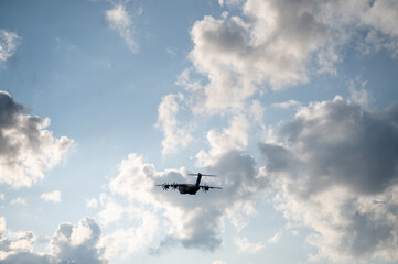 Cargo plane in moody cloudy sky, darl silhouette