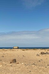 View of the strange, unfriendly but fascinating deserted landscape of the north coast of the island. Camper in the distance, free camping with sea view.