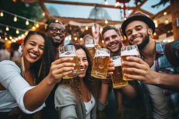  Group of happy people holding up beer glasses celebrating Oktoberfest, beer festival © Jasmina