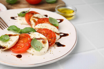 Delicious Caprese salad with balsamic vinegar on white table, closeup