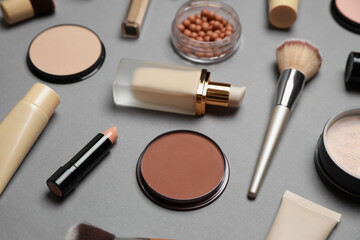 Face powders and other makeup products on grey background