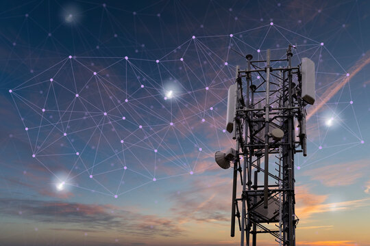Close-up of a mobile phone antenna in the evening sky with beautiful light atmosphere. The Global Network is simulated with transparent symbols.