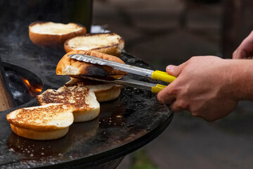 Cooking delicious Burgers. cooking meat burgers with bacon, cheese and vegetables, selective focus. bright plan.