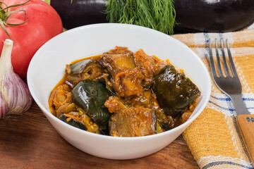 Eggplant pieces stewed with other vegetables in bowl close-up
