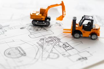 Toy construction machine builds model of house at the drawings.