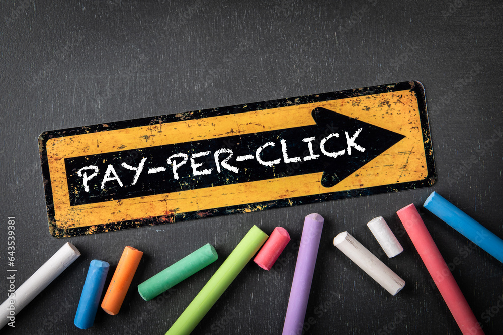 Canvas Prints pay per click concept. yellow directional arrow with text on a dark chalkboard background