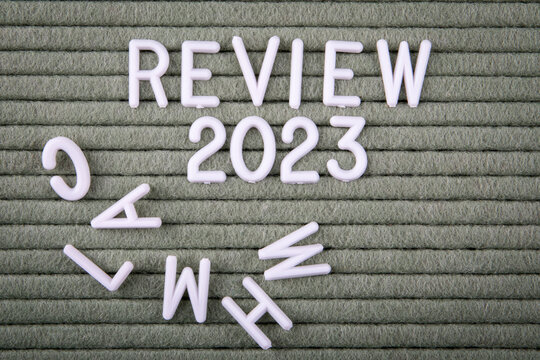 REVIEW 2023 Concept. White letters of the alphabet on a green background