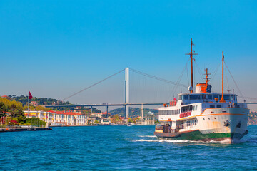 Obraz premium Sea voyage with old ferry (steamboat) on the Bosporus - Ortakoy mosque and Bosphorus bridge - Istanbul, Turkey 