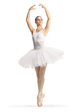 Full length profile shot of a ballerina in a white dress dancing with arms up