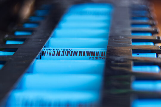 A used electric kick scooter battery pack close-up consisting of multiple 18650 3.7V batteries.