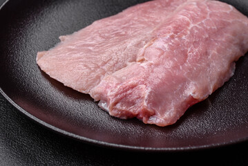 Fototapeta premium A piece of fresh juicy raw pork with salt, spices and herbs