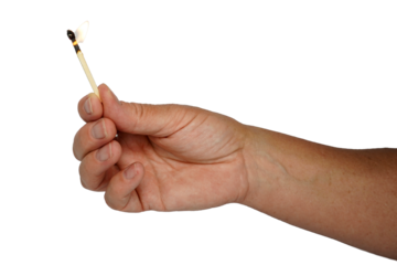 Hand holding burning match. Match burning.