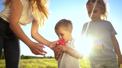 children conduct a relay race in nature in the park. happy family childhood dream concept. a group...