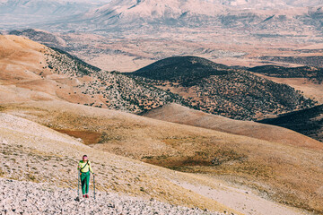 Bold Ascent: A fearless female mountaineer tackles nature's challenges, navigating rocks and cliffs...