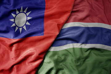 big waving national colorful flag of taiwan and national flag of gambia .