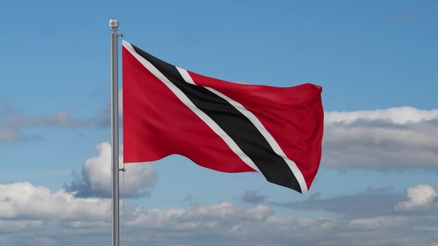 Trinidad and Tobago looped flag waving in the wind with blue sky and running clouds, cycle seamless loop video