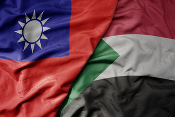 big waving national colorful flag of taiwan and national flag of sudan .