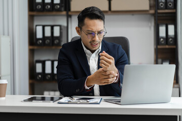 Business men have wrist pain after work hard in office feeling so pain and illness with Office syndrome symptom, healthcare office syndrome concept.