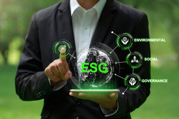 ESG Concepts. Environmental, Social and Corporate Governance.Businessman pressing Target button on the screen. Challenging ESG goals. ESG impact investing. Ethical and sustainable investing.