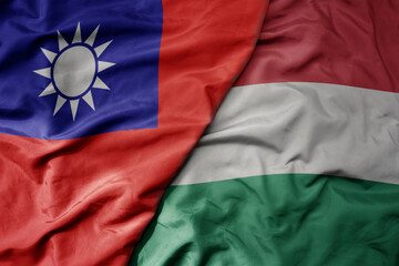 big waving national colorful flag of taiwan and national flag of hungary .