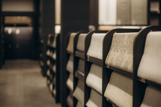 Samples of different wallpapers on store window racks