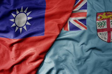 big waving national colorful flag of taiwan and national flag of Fiji .
