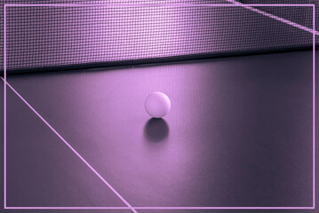 A small ball for playing tennis on the table. Pink tint of the image.