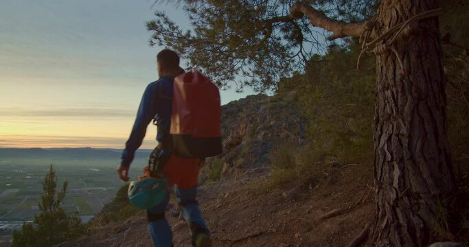 Two mountaineers discussing the route to follow, they watch the sun rising in the distance, Orihuela, Alicante, Spain - stock video