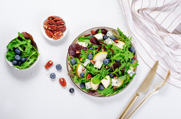 Fototapeta na wymiar Salad with Pear, Arugula, Blue Cheese and Blueberry, Delicious Fresh Salad on Bright Background