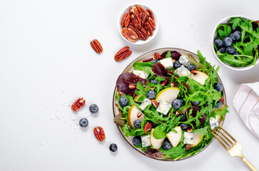 Salad with Pear, Arugula, Blue Cheese and Blueberry, Delicious Fresh Salad on Bright Background
