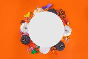 Halloween high-colored yellow background with colorful party holiday accessories and decor, spiders, cobwebs, pumpkins, bats, ghosts, top view flat lay copy space