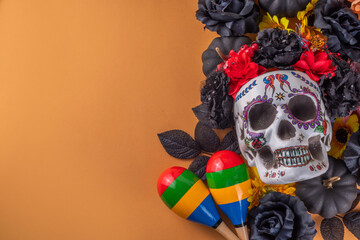 Dia de los muertos Feast flat lay, Mexican Day of the Dead holiday background with fall black, orange, yellow flowers, lightbox with text Dia de los muertos, colorful painted skull