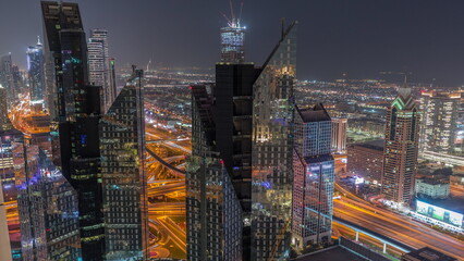 High-rise buildings on Sheikh Zayed Road in Dubai aerial night timelapse, UAE.