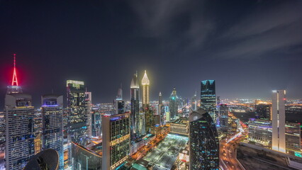 Skyline view of the high-rise buildings on Sheikh Zayed Road in Dubai aerial night timelapse, UAE.