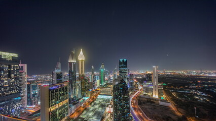 Skyline panoramic view of the high-rise buildings on Sheikh Zayed Road in Dubai aerial night timelapse, UAE.